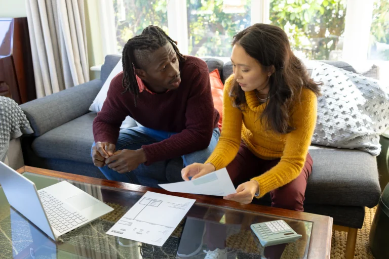 couple discussing documents at home on the sofa 2026 03 25 00 53 41 utc