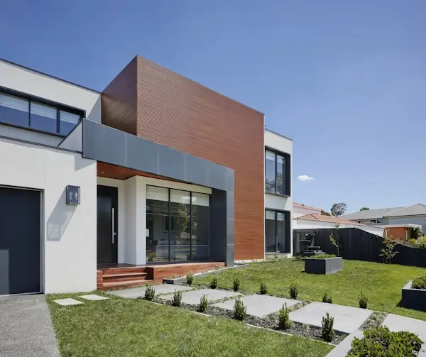 Modern two-story home with geometric facade and landscaped front yard