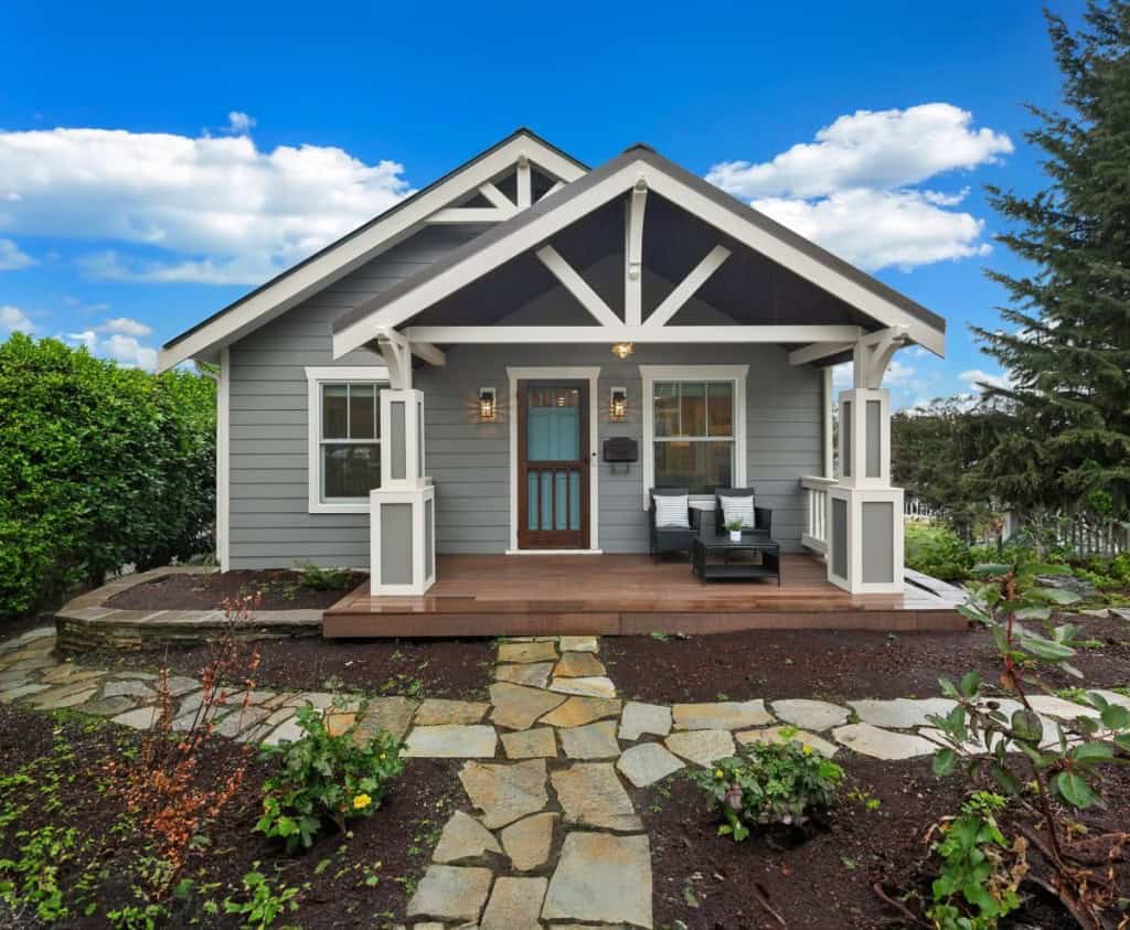 Gray craftsman-style home with covered porch and stone walkway